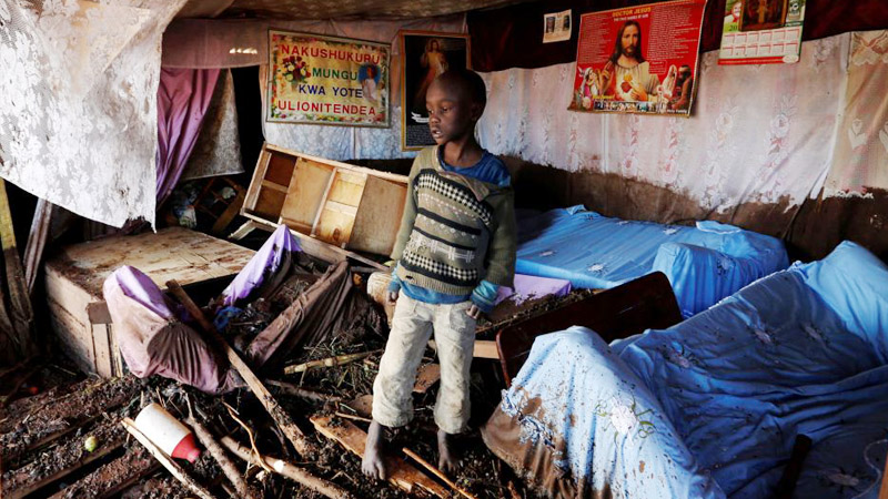 Kenya Boy in Home damaged by flooding